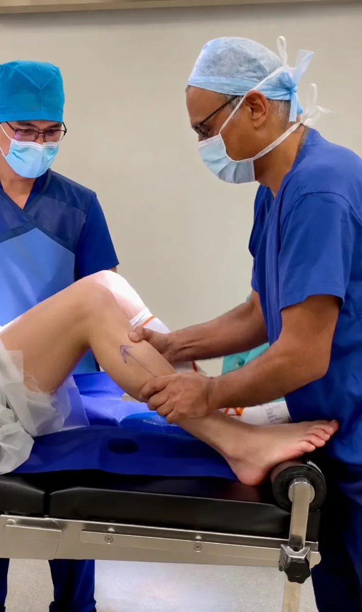 Mr Trikha assessing a knee ligament injury in theatre