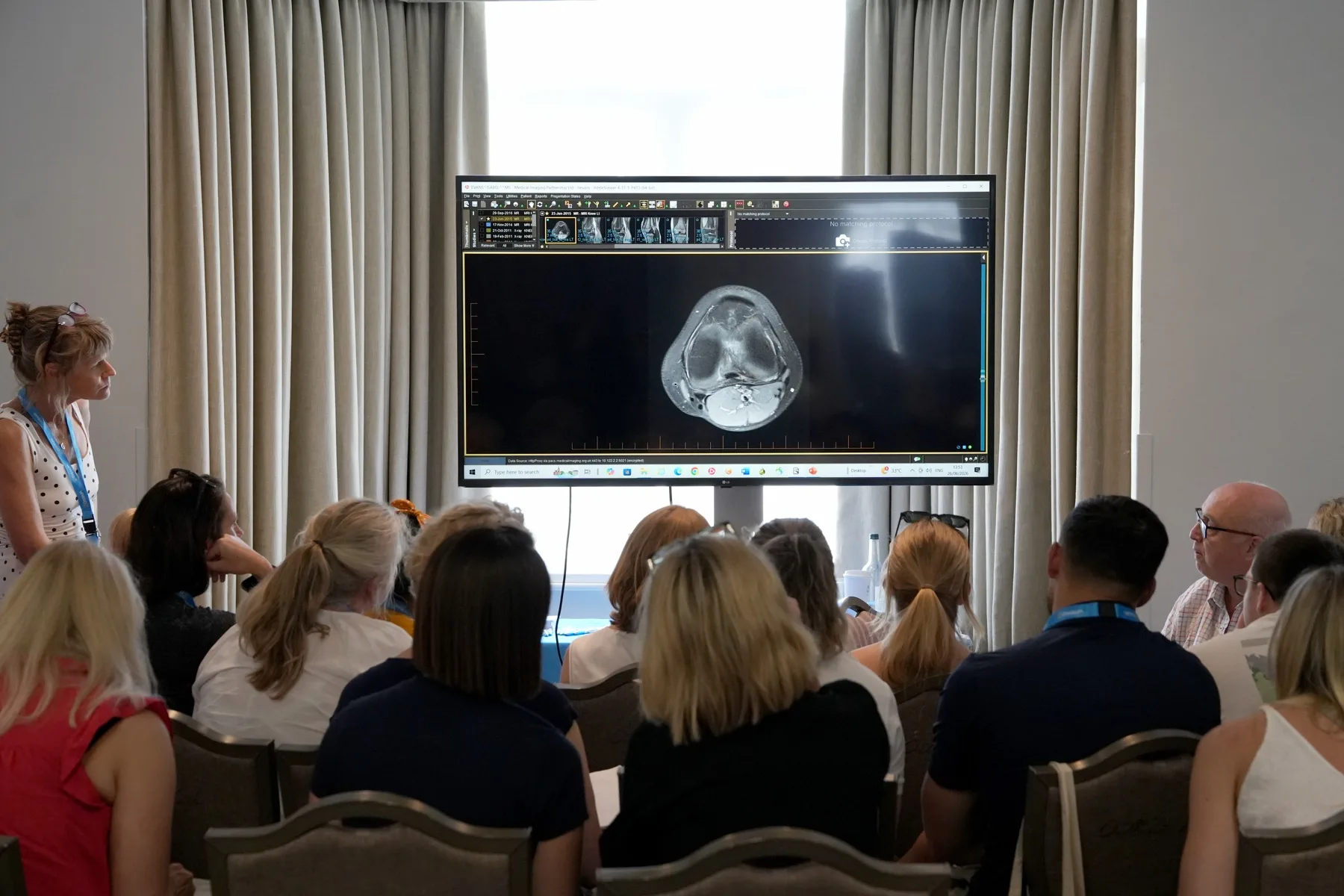 Delegates reviewing a knee MRI scan on screen