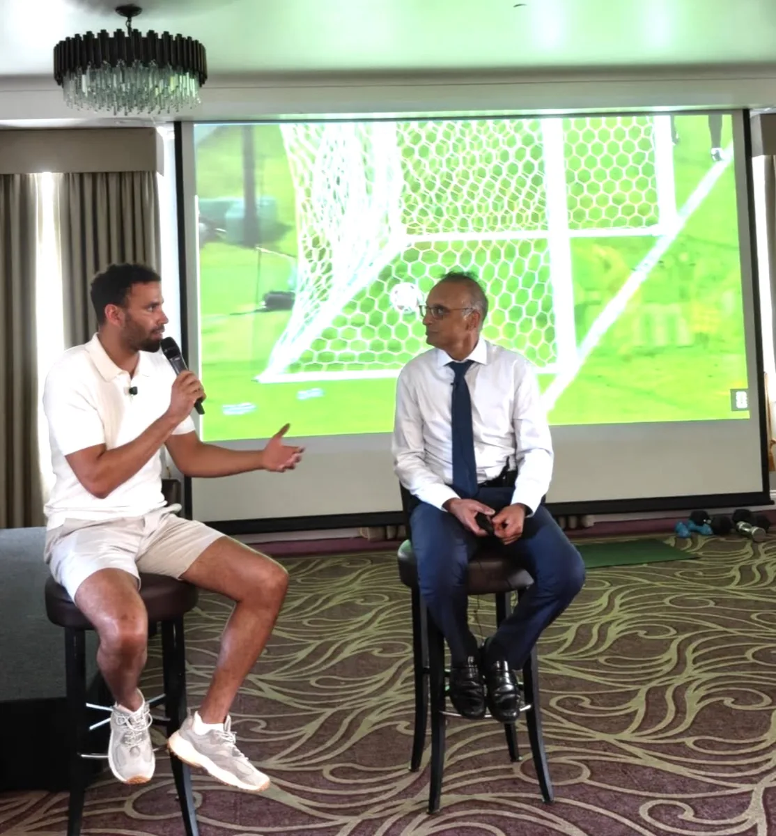 Mr Trikha in conversation with Hal Robson-Kanu at the Surrey Knee Symposium