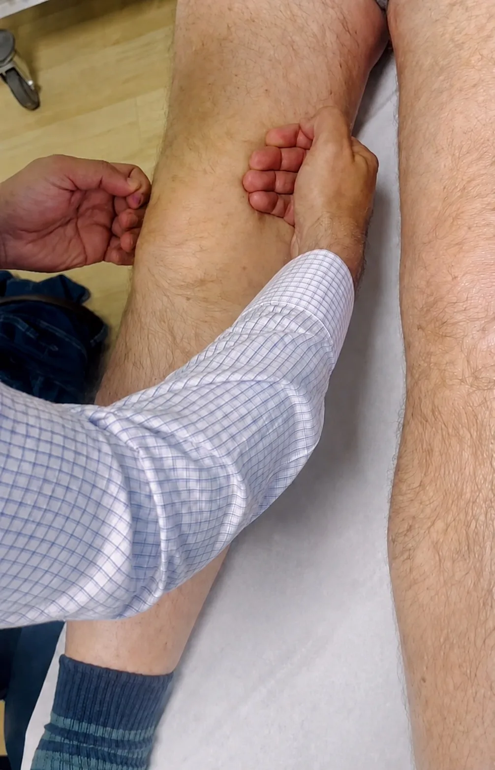 Mr Trikha examining a swollen knee